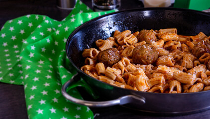 homemade pasta with meatballs in tomato sauce