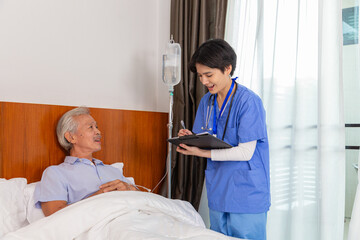 Female doctor or general practitioner listens to the woman and writes the information in retirement home. - 553681791