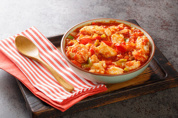 Bacalao al ajoarriero Cod with peppers and tomato sauce closeup on the bowl on the table. Horizontal
