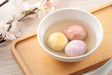 Colored glaze style big tangyuan with cherry blossom flower and syrup soup.
