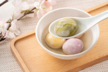 Colored glaze style big tangyuan with cherry blossom flower and syrup soup.