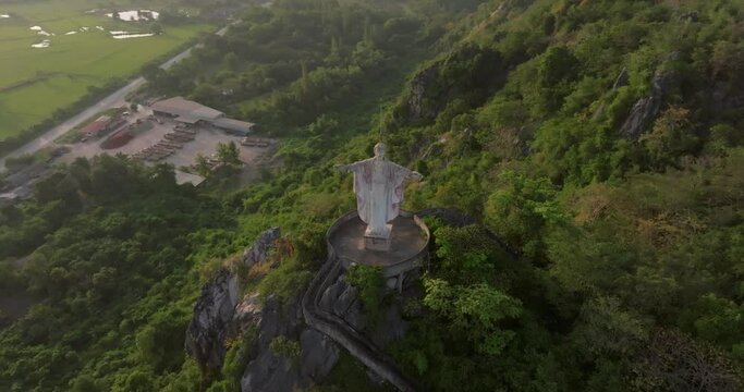 An aerial view of Christ the Redeemer on the mountain stands prominently at Hup Pha Sawan in Ratchaburi near the Bangkok, Thailand.