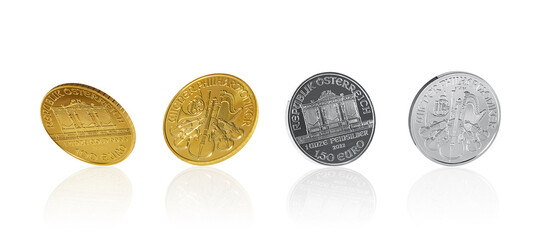 Isolate of golden and silver Austrian  Philharmonic coins in different angles on white background
