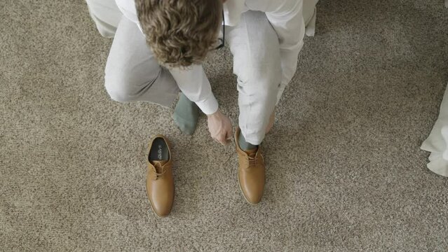 Groom getting ready on his wedding day. Groom putting on shoes. Shot in 4K 60FPS for high quality slow motion. To purchase entire event raw at wholesale price email willneatheryyahoo.com.
