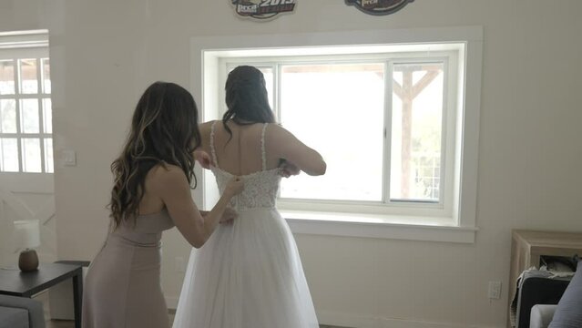 Mother zipping up brides dress. Mother and bride. Shot in 4K 60 FPS for high quality slow motion. To purchase entire event raw at wholesale price email willneatheryyahoo.com.