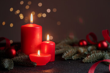 Red candles on dark background with bokeh lights
