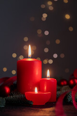 Red candles on dark background with bokeh lights