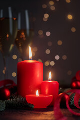 Red candles on dark background with bokeh lights