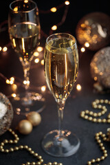 New year's eve, glass of champagne on black table, Cristmas decoration background