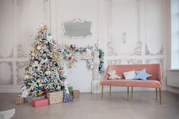 Christmas and New Year card with decorated fur tree, pink sofa, mirror on white wall background.
