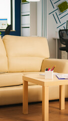 Interior of empty creative office with dusky light, new business, start up company with no people in it. Company with modern design and confortable couch with nobody in it, place of work startup