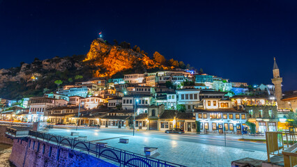 Evening view to Berat, historic city in the south of Albania at night with all lights flashing and...