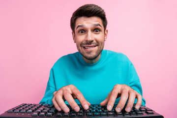 Photo portrait of handsome young guy bite lips programmer addicted internet user wear trendy blue look isolated on pink color background
