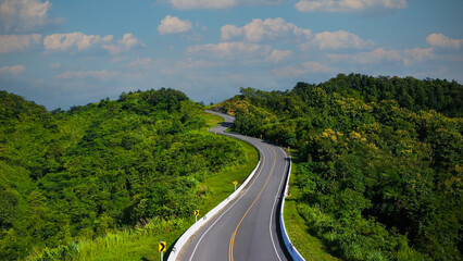 The highway stairs to the sky of road trough with green forest  as the nature landscape background