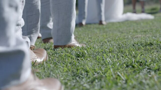 Close up shot of groomsmen shoes, lined up during wedding ceremony. Shot in 4K 60FPS for high quality slow motion. Purchase entire event raw at wholesale price email willneatheryyahoo.com.