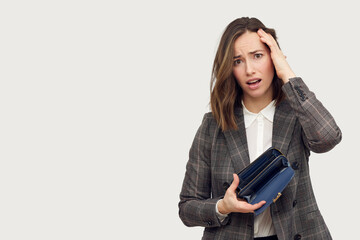 Young beautiful business woman on white background holding an empty wallet looking frustrated.