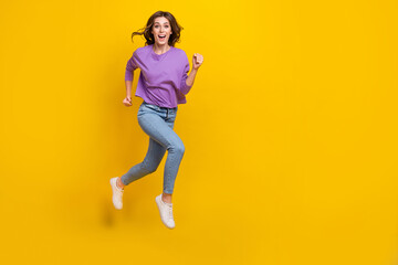 Fototapeta na wymiar Full size photo of crazy carefree girl jumping running empty space isolated on yellow color background