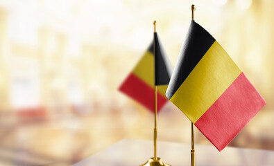 Small flags of the Belgium on an abstract blurry background