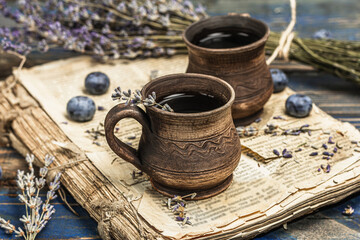 Fototapeta na wymiar The concept of rustic style tea. Lavender flowers and blueberries. Vintage book