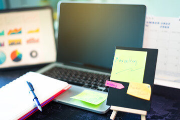 Write a note on the desk of the marketing officer.