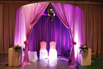 Indian stage decoration with multi color flowers, props and lights. wedding stage decoration, flower shelter type