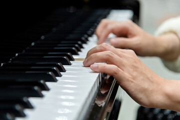 Close up of woman hands playing piano