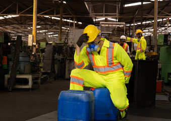 worker wearing uniform protection chemicals.Industrial worker holding plastic bottle with chemicals in factory.