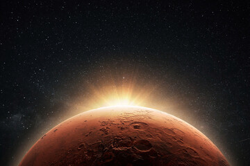 Amazing beautiful planet Mars with craters in stellar space with the sunrise light.