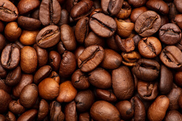 Grains of black coffee as a background.