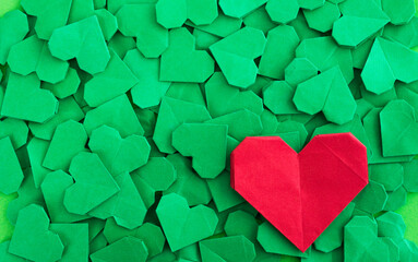 Obraz premium Red origami heart on green origami hearts