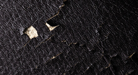 Cracked leather on a chair as an abstract background.