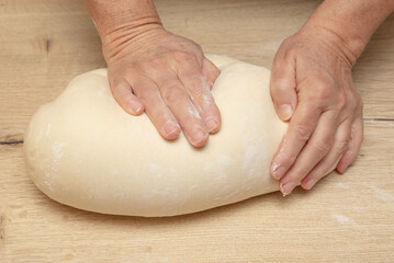 Hand kneading flour dough.