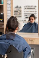 Vertical photo of woman ready and waiting to have her hair done at the beauty salon.