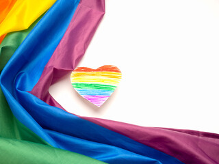 The rainbow flag or LGBT flag and a heart shape symbol on a white background