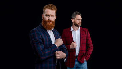 studio shot of two handsome men in menswear jackets. men in menswear isolated on black background