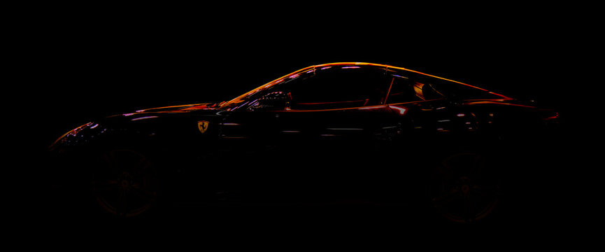 Ferrari Portofino sports car in silhouette with illuminated roof in Essen, Germany December 5, 2022