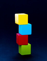 Obraz premium Wooden building blocks stacking on black background
