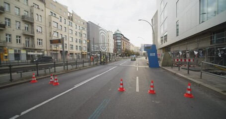 High angle view of road with traffic cones. Tilt up reveal street in city with timing point of sports event. Marathon run race, Berlin, Germany
