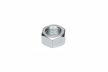 One steel nut. On an isolated white background. With scratches. Close-up studio macro photography.