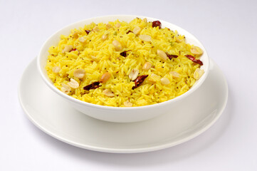 Lemon Rice or fodnicha bhat is South Indian turmeric rice or maharashtrian recipe using leftover rice garnished with nuts curry leaves and lemon juice