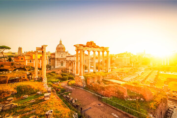 Fototapeta na wymiar Forum - Roman ruins with cityscape of Rome with warm sunrire light, Italy