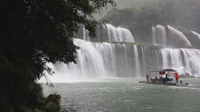 People getting closer to the biggest waterfall of Ban Gioc, Vietnam also known as Detian in China, near the border between North Vietnam and South China