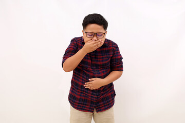 Asian boy standing holding her stomach and feeling nauseous and going to vomit. Isolated on white - obrazy, fototapety, plakaty