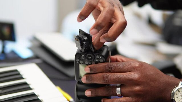 Man repairing the camera flash by replacing the bottom.