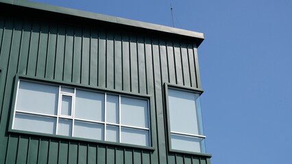 Obraz premium Rectangular windows on green building facade