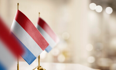 Small flags of the Netherlands on an abstract blurry background