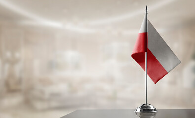 A small Poland flag on an abstract blurry background