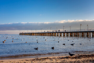 Wooden pier by the Baltic Sea in Gdynia Orlowo in winter scenery, Poland