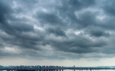 Dark clouds over a city by the sea