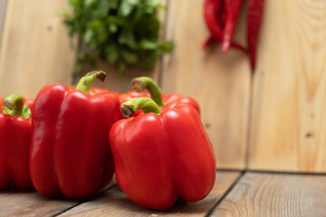 Red peppers on a wooden background